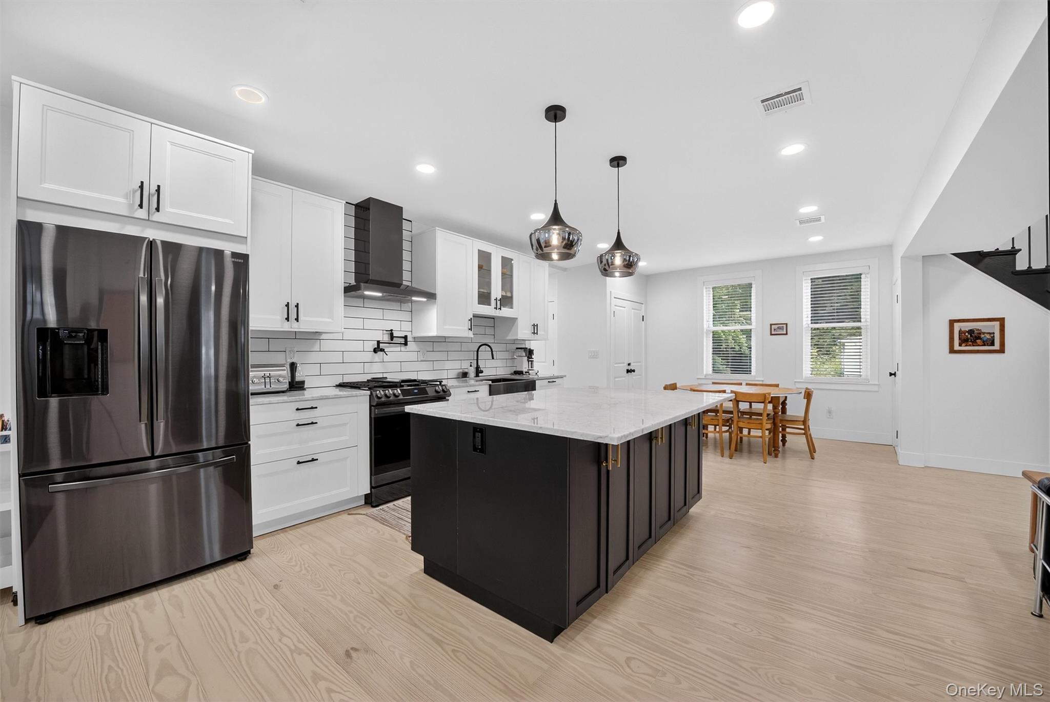 39 Frost Lane Cornwall, NY 12518 - Photo 14 of 39 a kitchen with stainless steel appliances kitchen island granite countertop a refrigerator a stove a sink dishwasher and a refrigerator with wooden floor