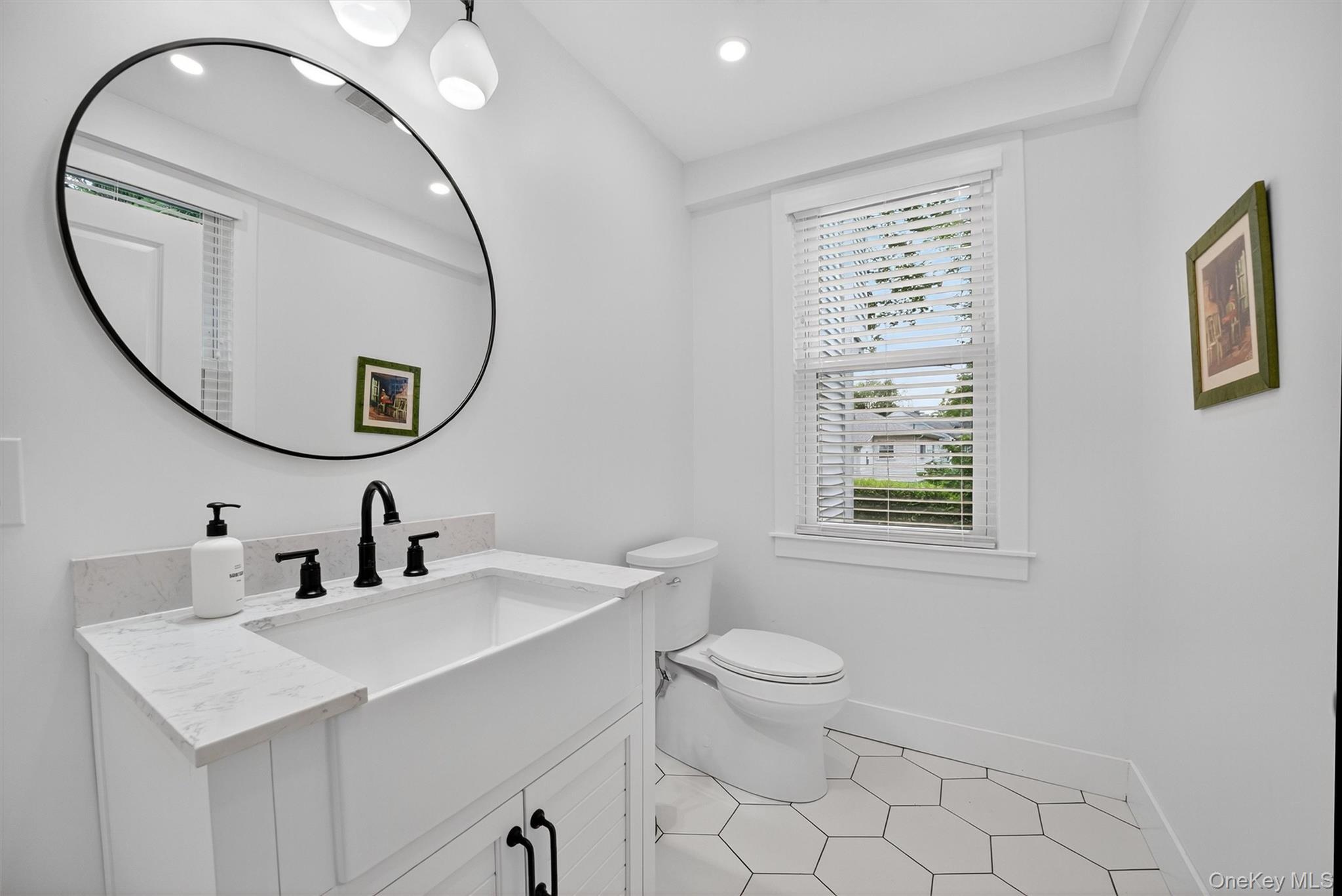 39 Frost Lane Cornwall, NY 12518 - Photo 15 of 39 a bathroom with a sink a mirror a toilet and a window