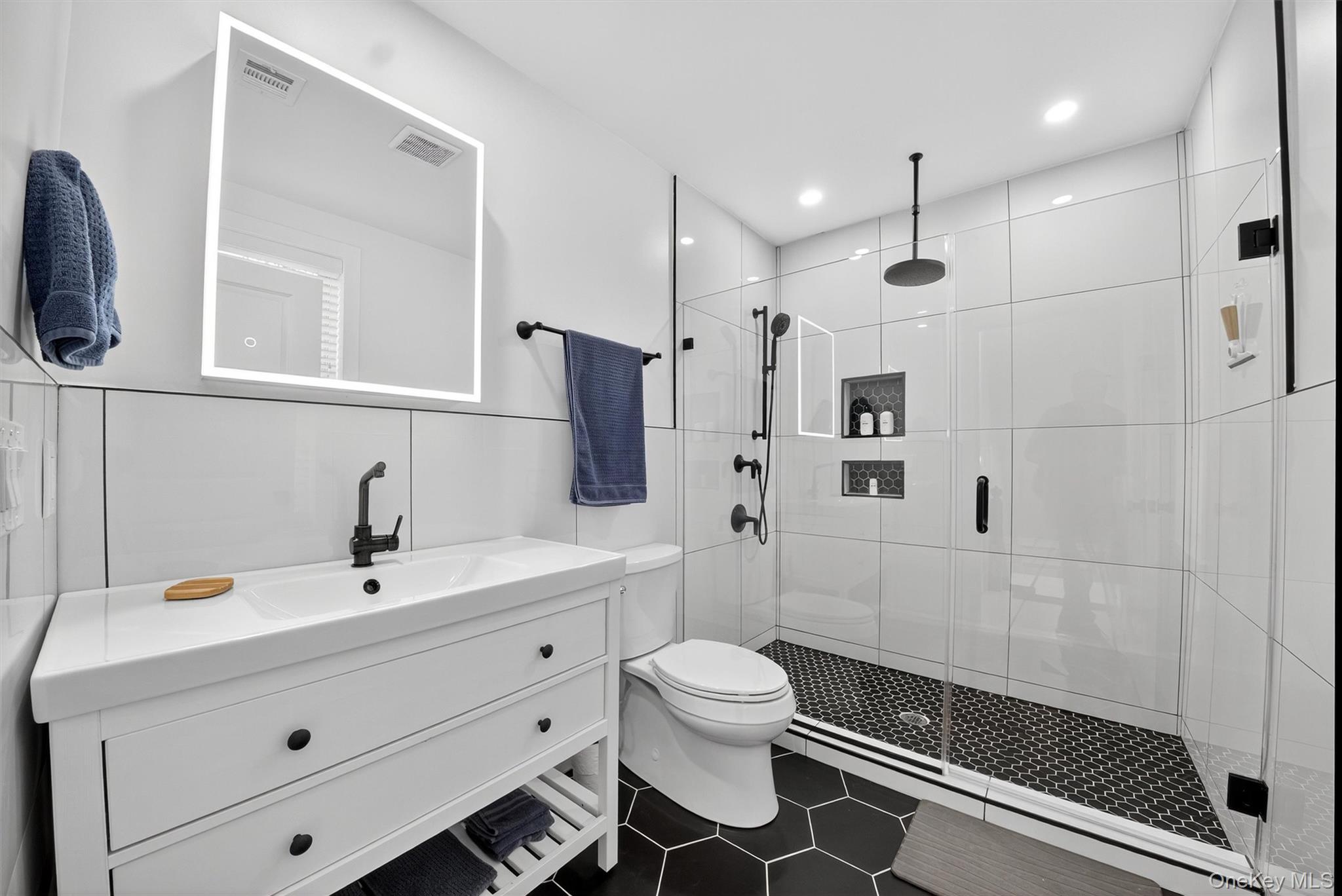 39 Frost Lane Cornwall, NY 12518 - Photo 25 of 39 a bathroom with a sink a toilet a mirror and shower