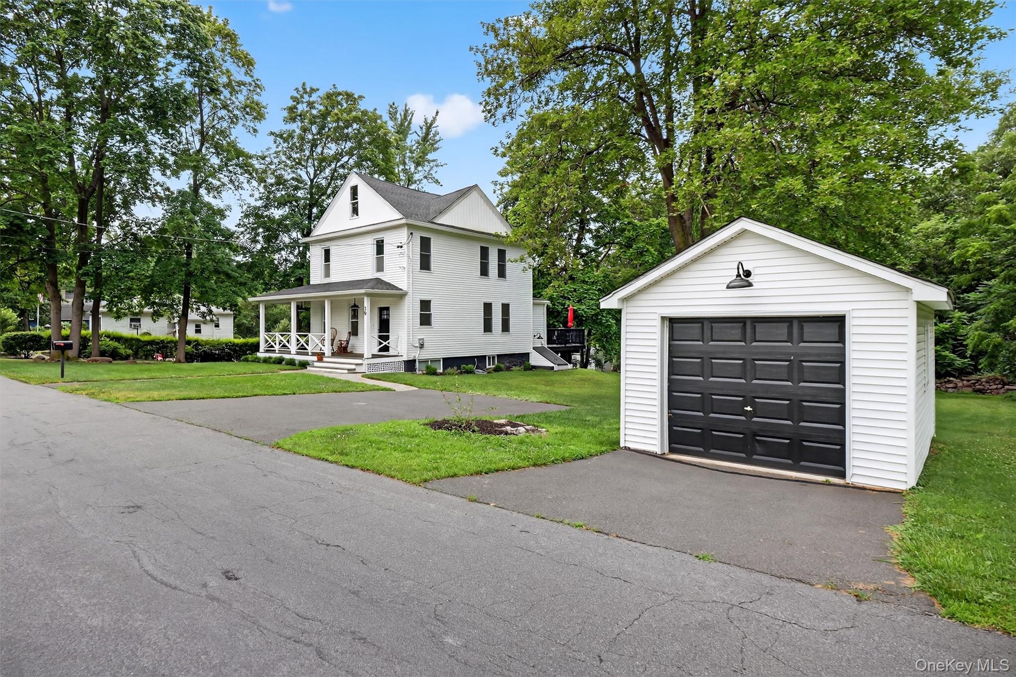 39 Frost Lane Cornwall, NY 12518 - Photo 33 of 39 a front view of a house with a yard and garage