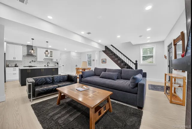 a living room with furniture a rug and a flat screen tv