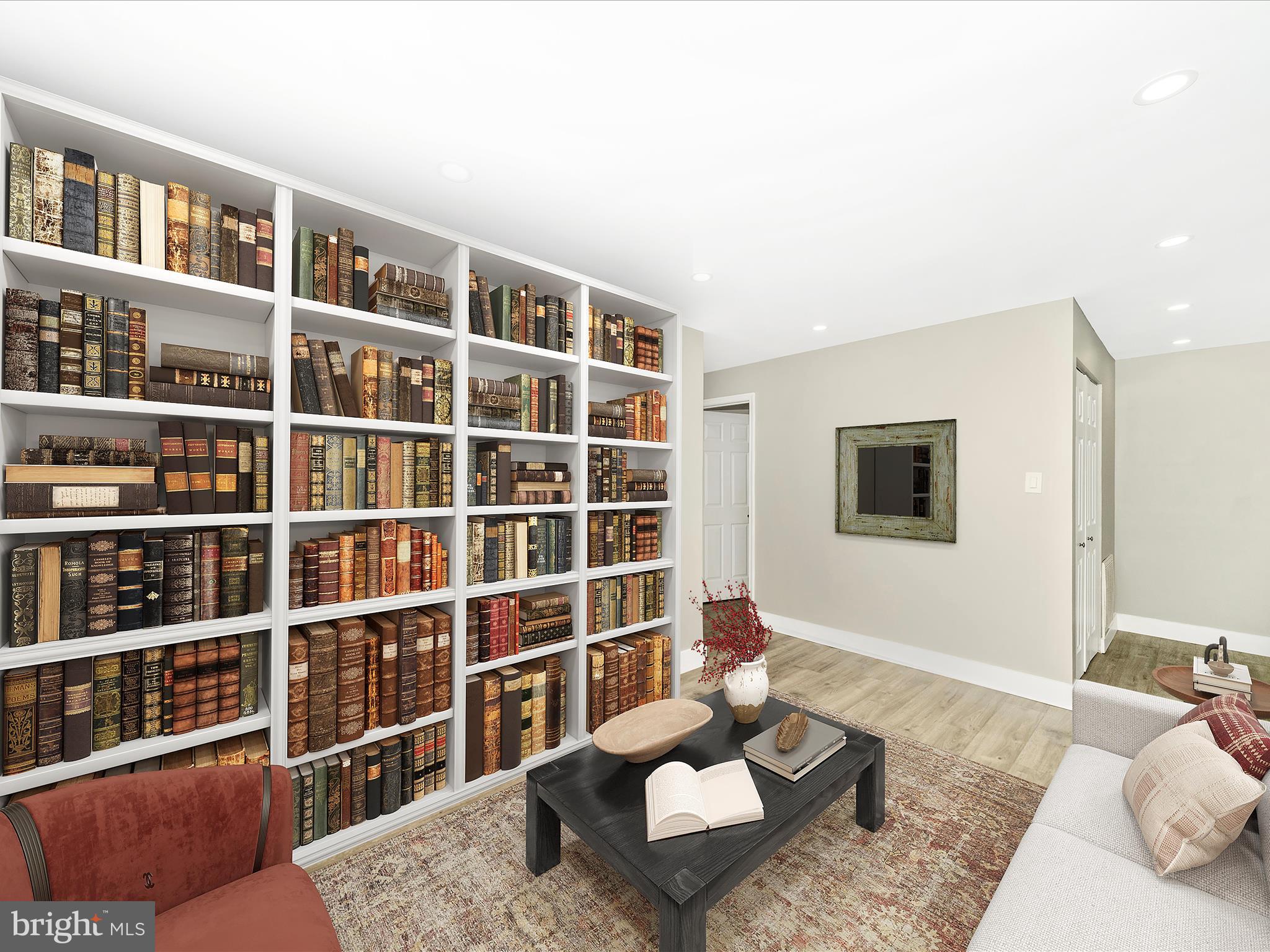 1040 Deer Ridge Drive, Unit 508 Baltimore, MD 21210 - Photo 35 of 66 a living room with furniture and a book shelf