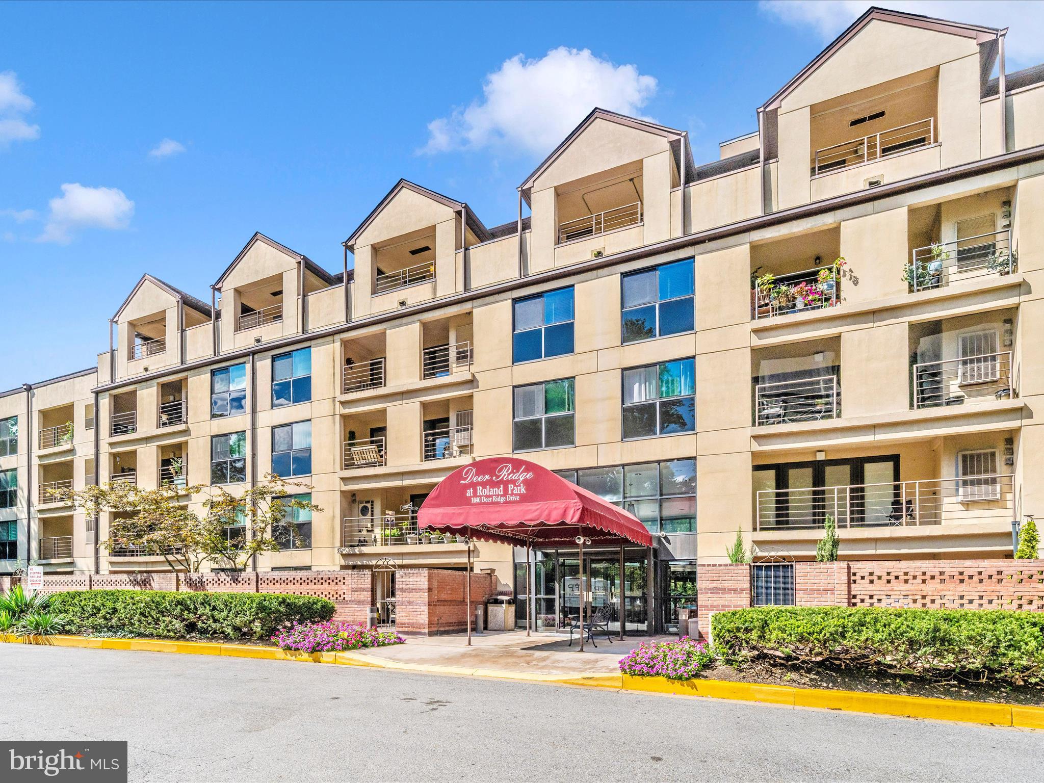 1040 Deer Ridge Drive, Unit 508 Baltimore, MD 21210 - Photo 61 of 66 a front view of multi story residential apartment building with retail shops