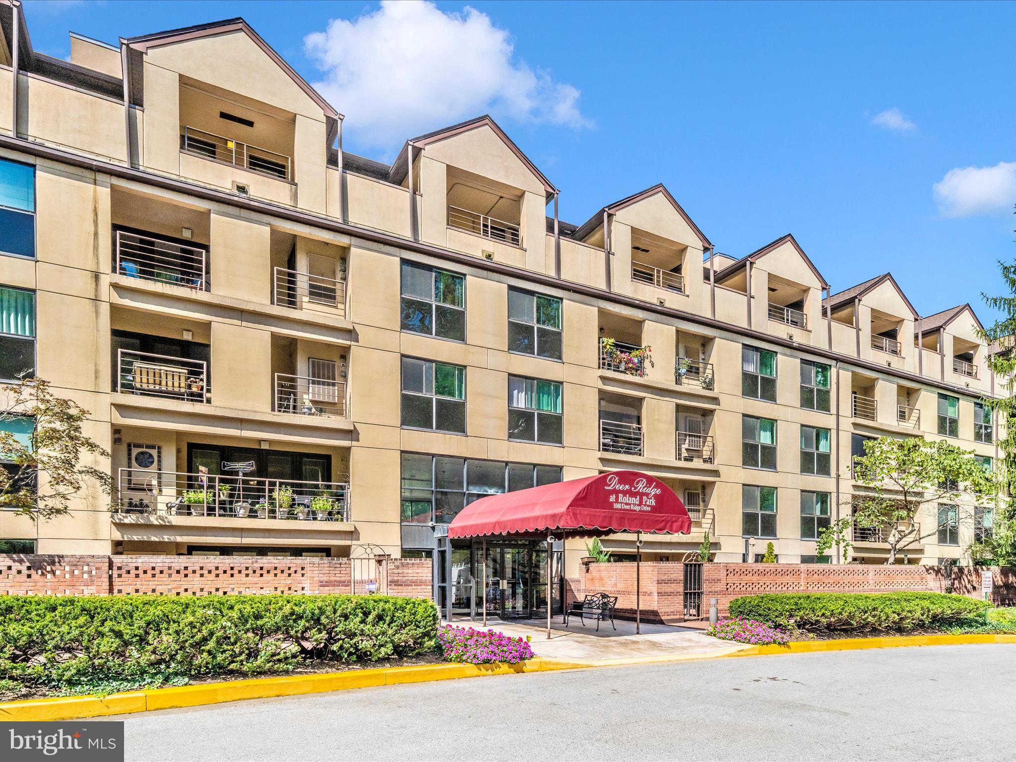 1040 Deer Ridge Drive, Unit 508 Baltimore, MD 21210 - Photo 62 of 66 front view of a building with a yard