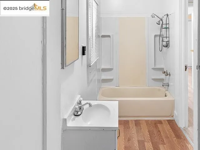 a bathroom with a sink a mirror and a bathtub