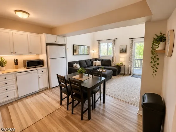 a kitchen with a table chairs refrigerator and cabinets