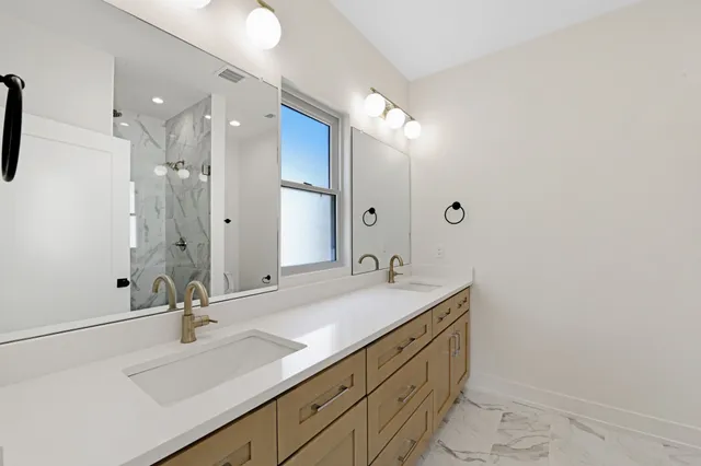 a bathroom with a sink double vanity and a mirror