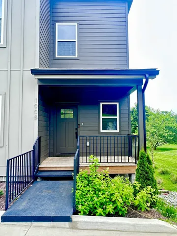 a view of a wooden house with a small yard