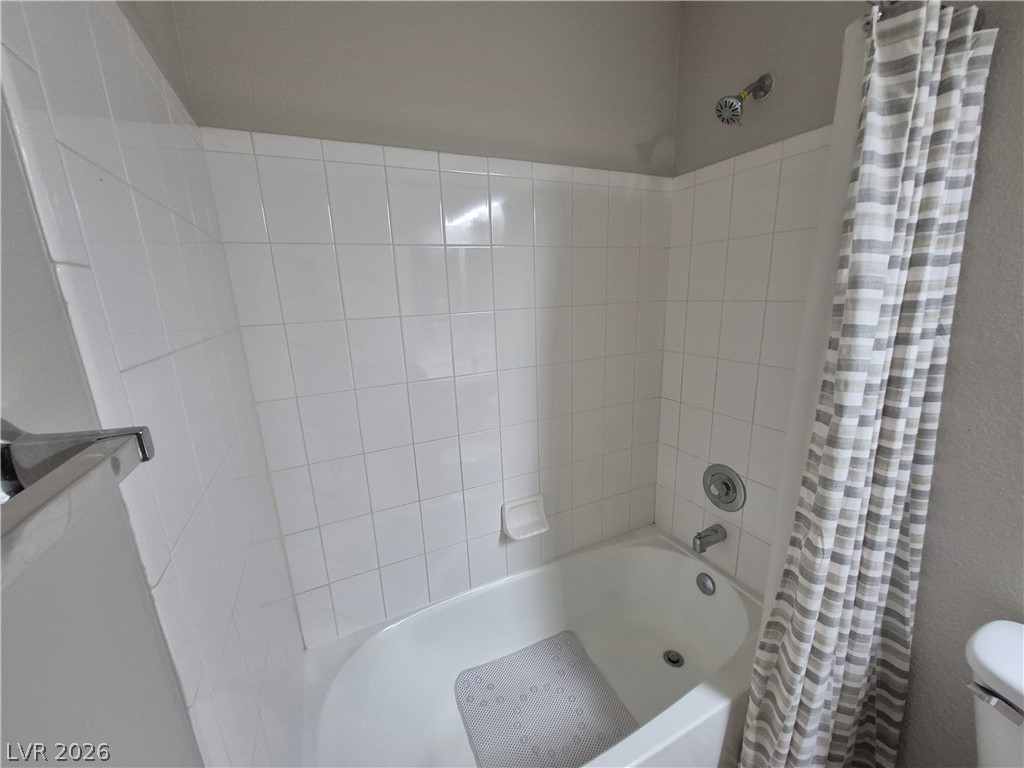 2053 Quarry Ridge Street, Unit 201 Las Vegas, NV 89117 - Photo 15 of 21 White subway tile surrounds the bath and shower combination.