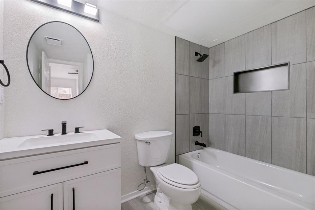 2240 Tarpley Road, Unit 92 Carrollton, TX 75006 - Photo 14 of 22 a bathroom with a sink a toilet and a mirror