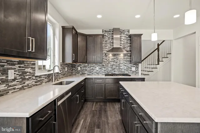 a kitchen with stainless steel appliances kitchen island granite countertop a sink stove and cabinets