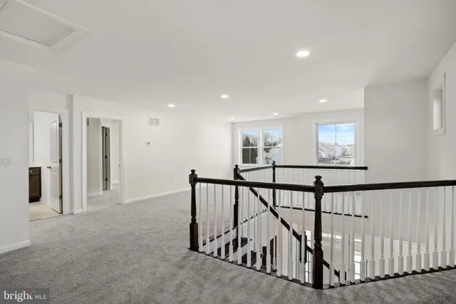 a bathroom with a sink a toilet a mirror and vanity