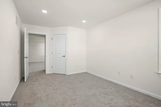 a living room with furniture a flat screen tv and wooden floor
