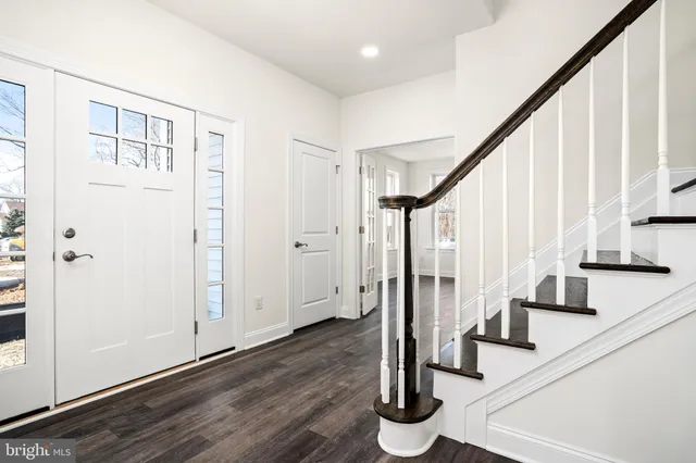 a view of entryway with wooden floor and staircase