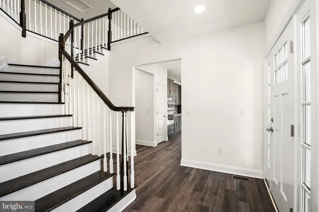 a view of entryway with wooden floor and stairs