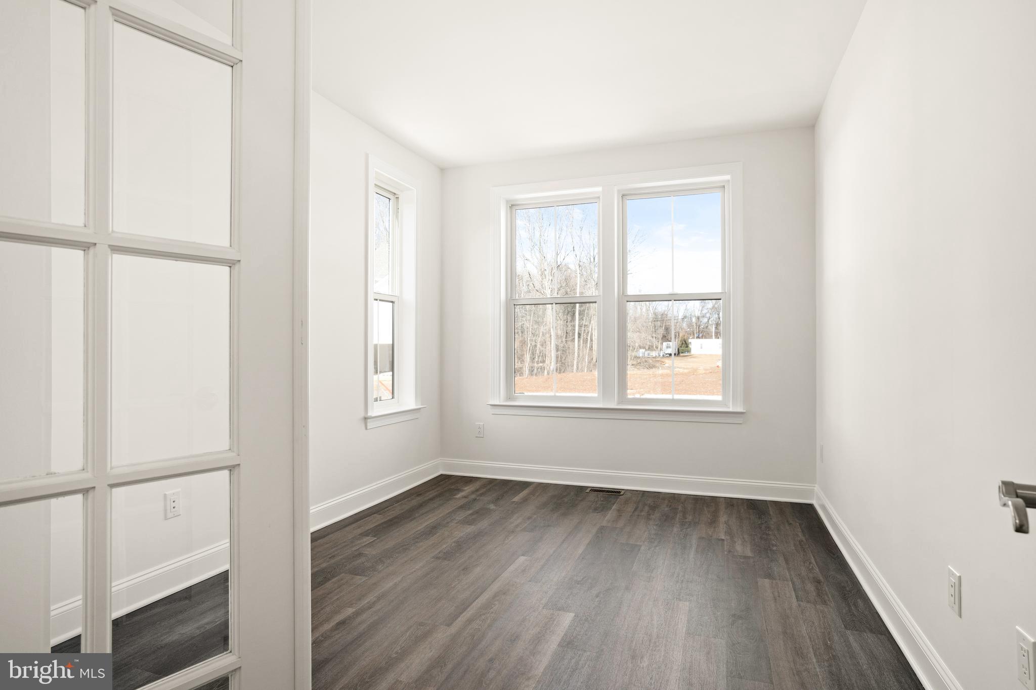 33 Kay Chiarello Way Hamilton, NJ 08690 - Photo 8 of 42 an empty room with wooden floor and windows