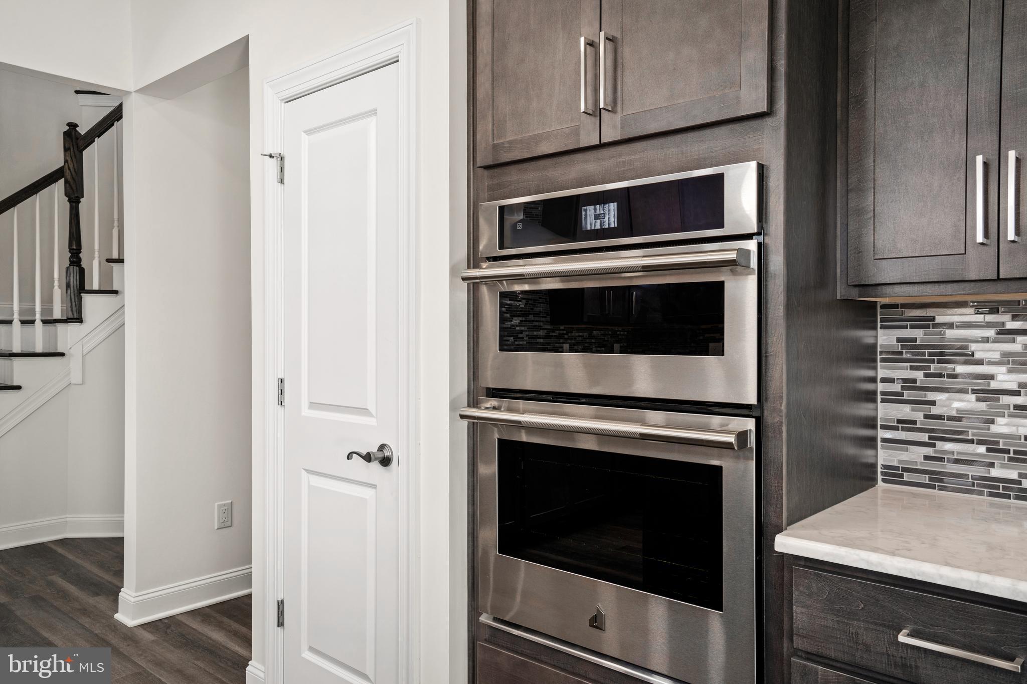 33 Kay Chiarello Way Hamilton, NJ 08690 - Photo 10 of 42 a kitchen with granite countertop white cabinets and stainless steel appliances