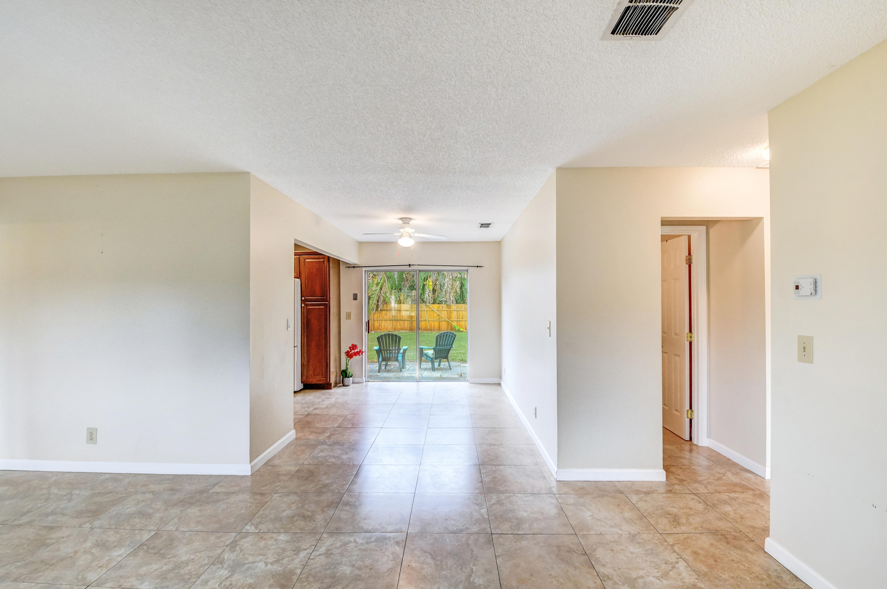 19594 Liberty Road Boca Raton, FL 33434 - Photo 14 of 53 a view of an empty room with wooden floor and a window