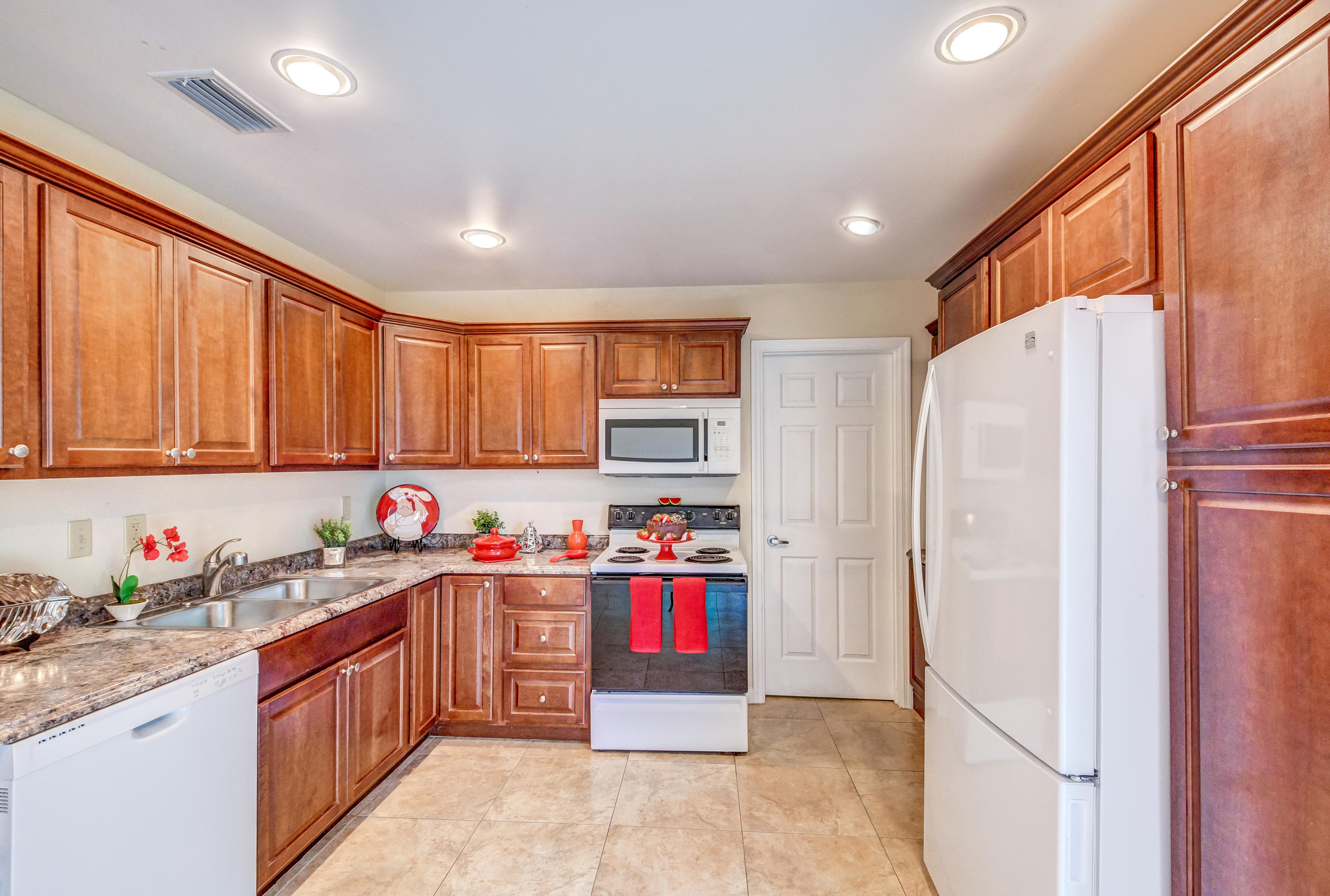 19594 Liberty Road Boca Raton, FL 33434 - Photo 19 of 53 a kitchen with stainless steel appliances granite countertop a refrigerator and a stove top oven