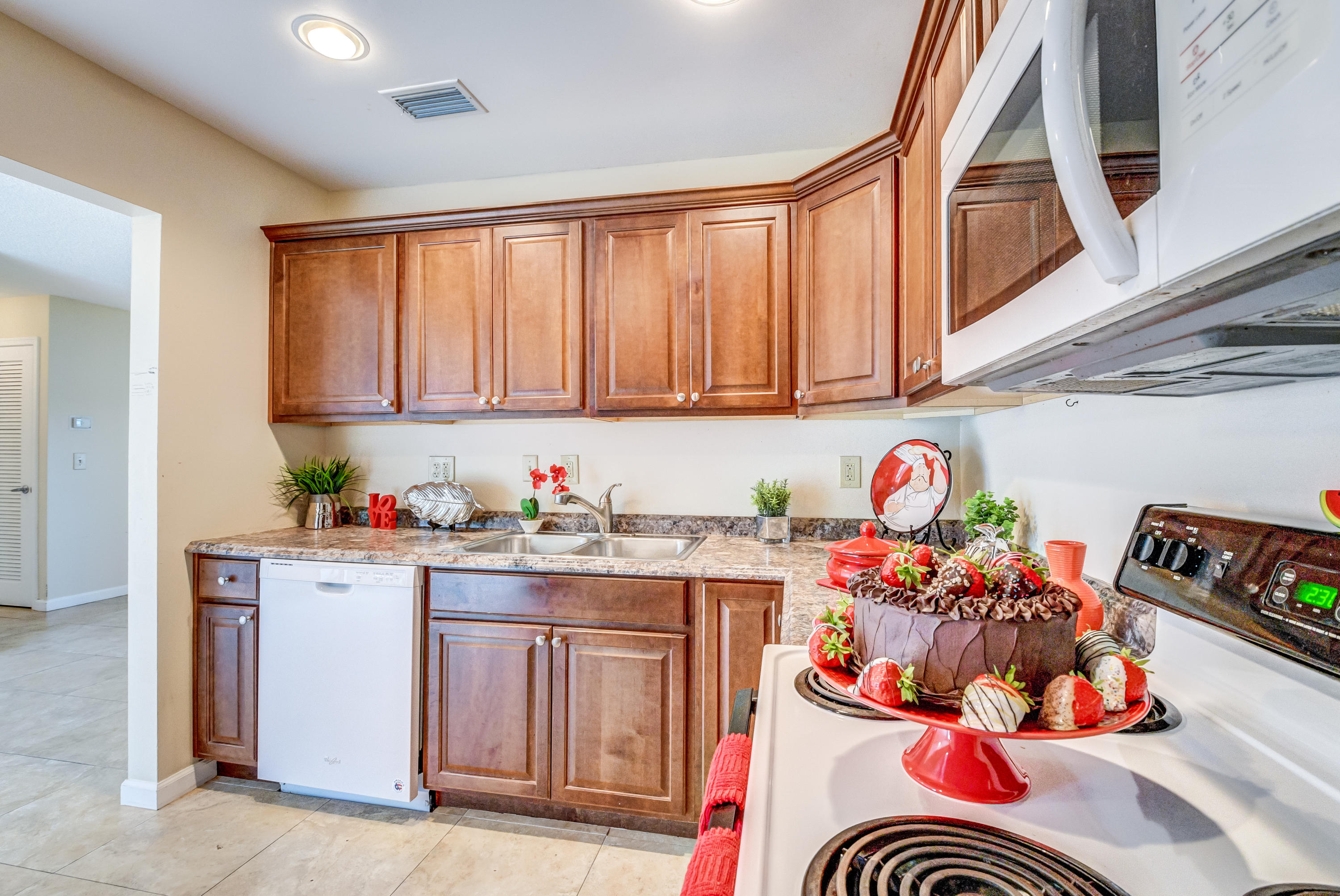 19594 Liberty Road Boca Raton, FL 33434 - Photo 21 of 53 a kitchen with a white stove top oven and cabinets