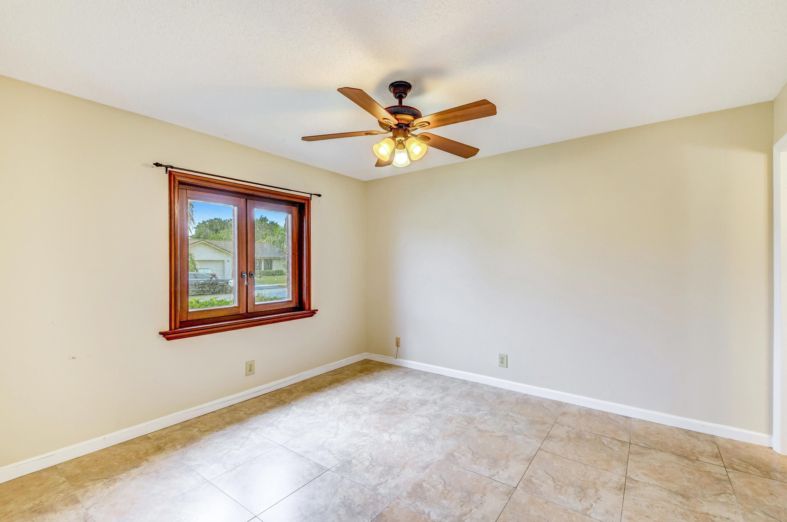 19594 Liberty Road Boca Raton, FL 33434 - Photo 27 of 53 a view of a livingroom with a ceiling fan and a window