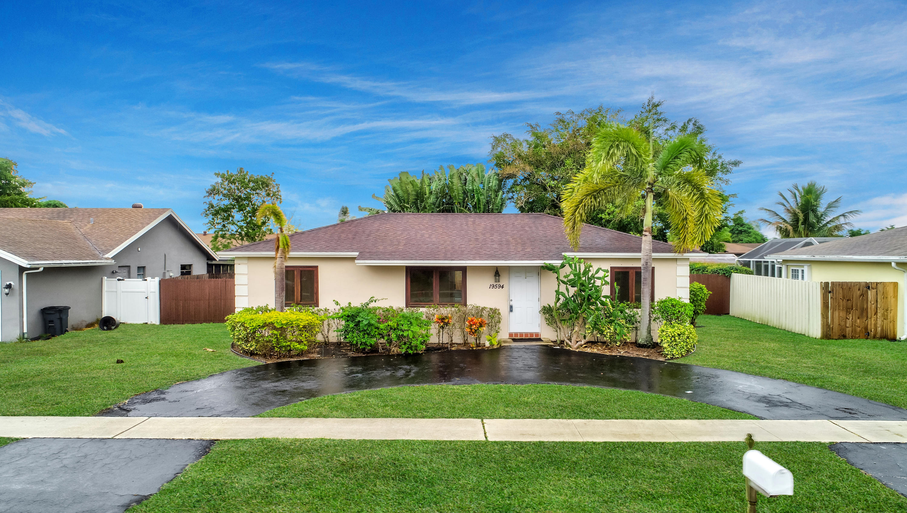 19594 Liberty Road Boca Raton, FL 33434 - Photo 3 of 53 a front view of a house with a garden