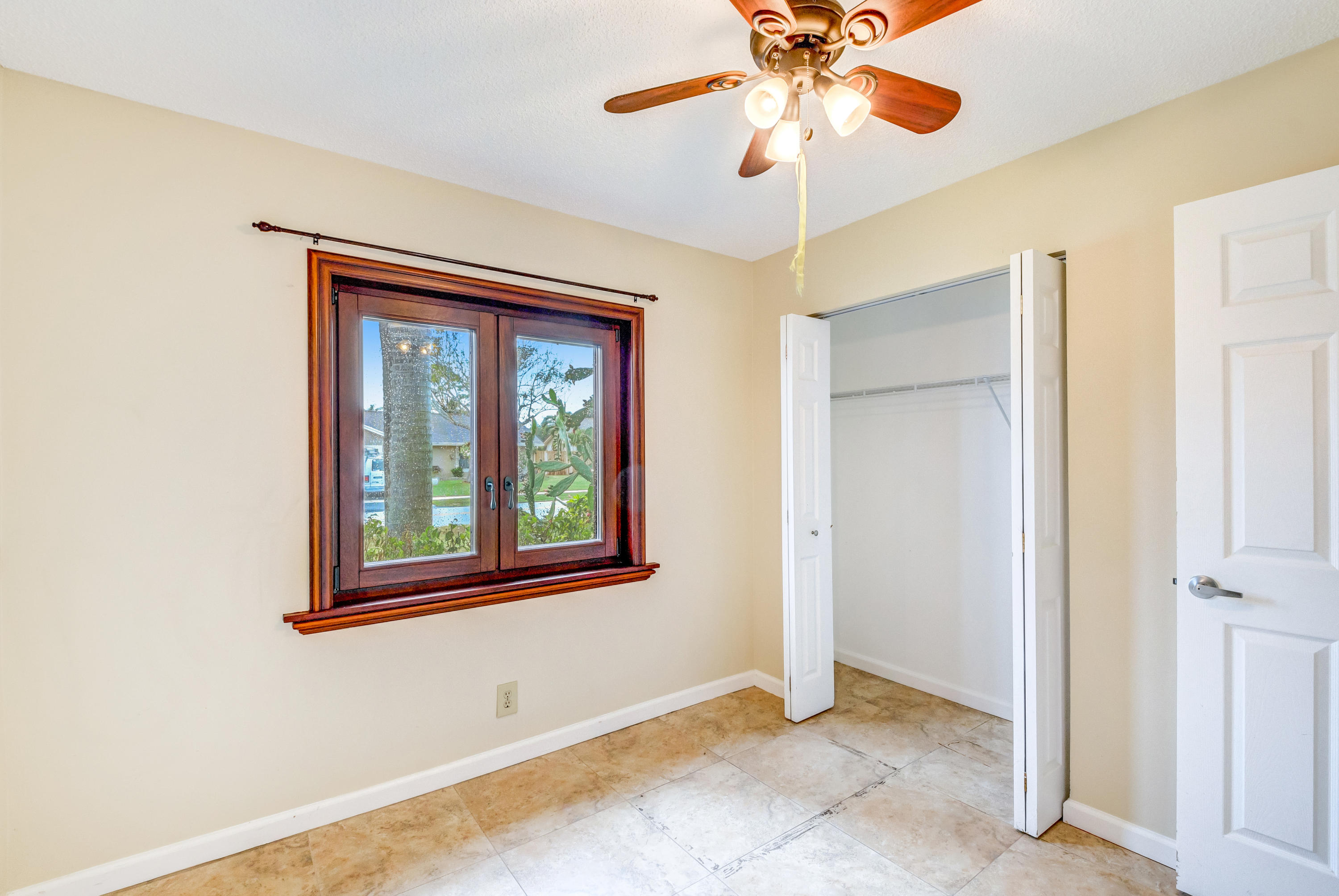 19594 Liberty Road Boca Raton, FL 33434 - Photo 32 of 53 an empty room with window and ceiling fan