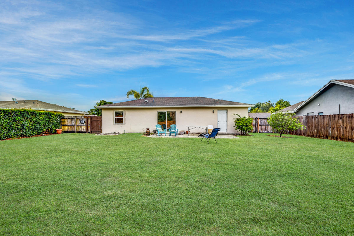 19594 Liberty Road Boca Raton, FL 33434 - Photo 40 of 53 a front view of a house with garden