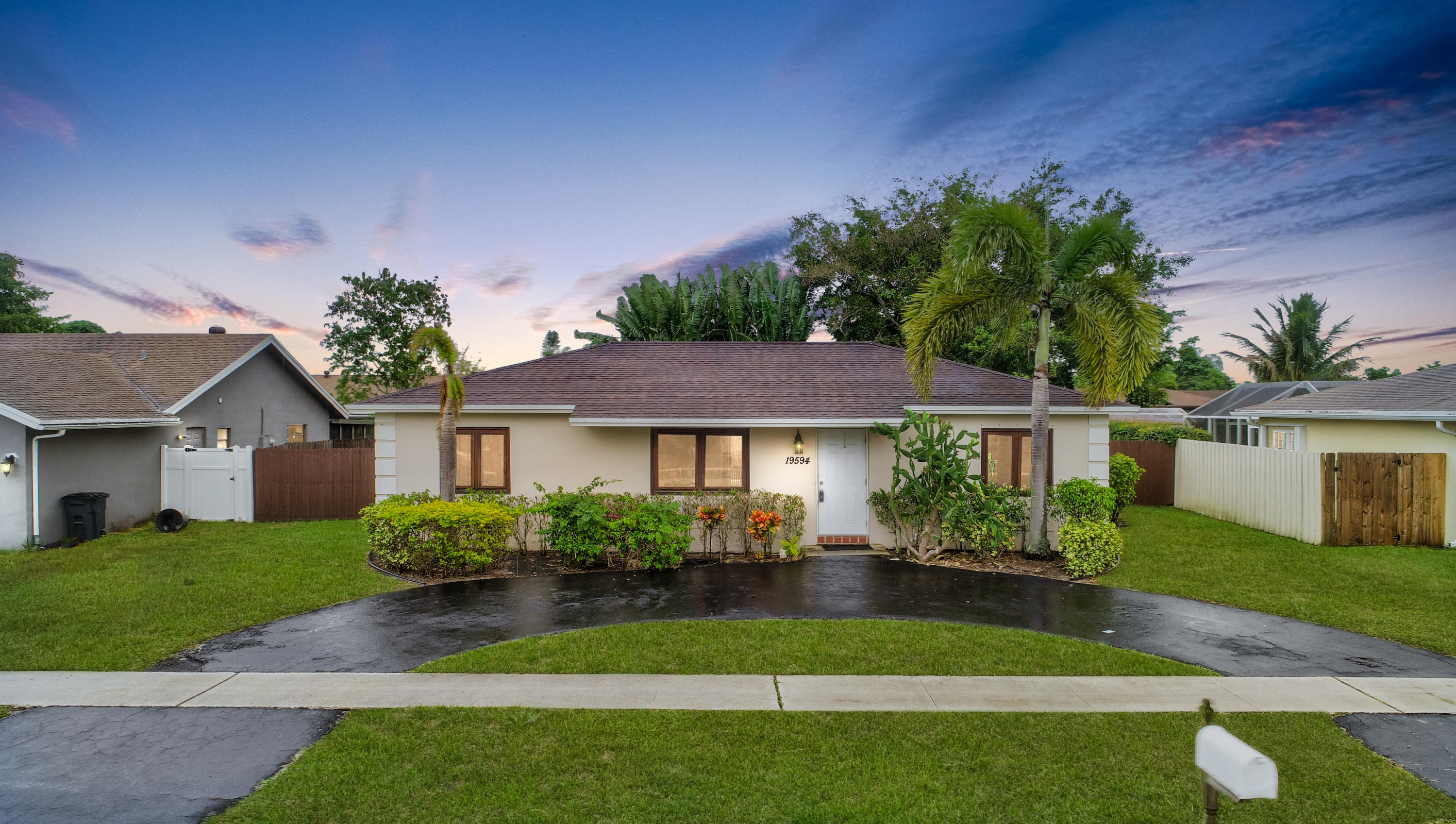 19594 Liberty Road Boca Raton, FL 33434 - Photo 4 of 53 a front view of a house with a garden