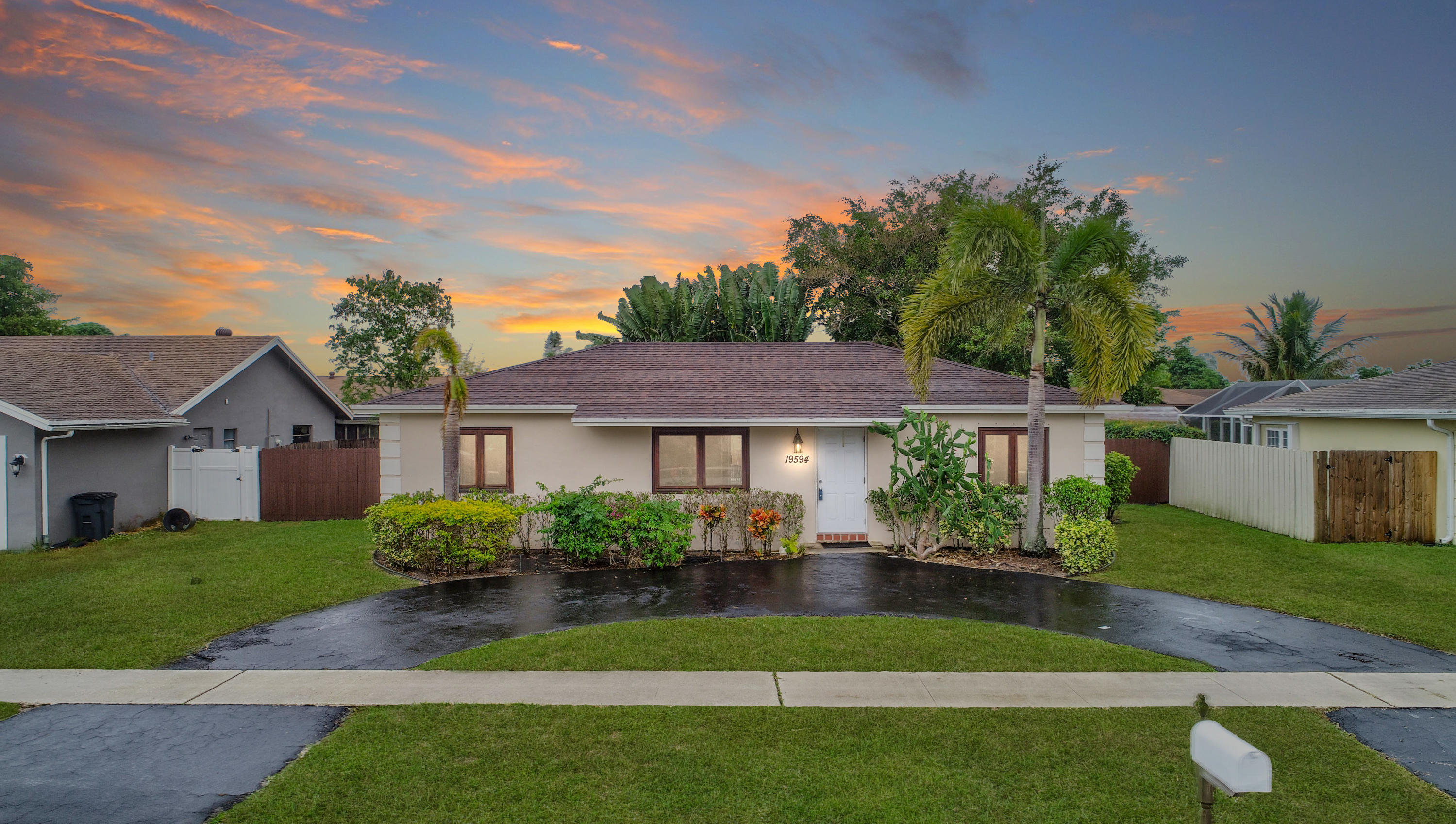 19594 Liberty Road Boca Raton, FL 33434 - Photo 49 of 53 a front view of a house with a garden and plants