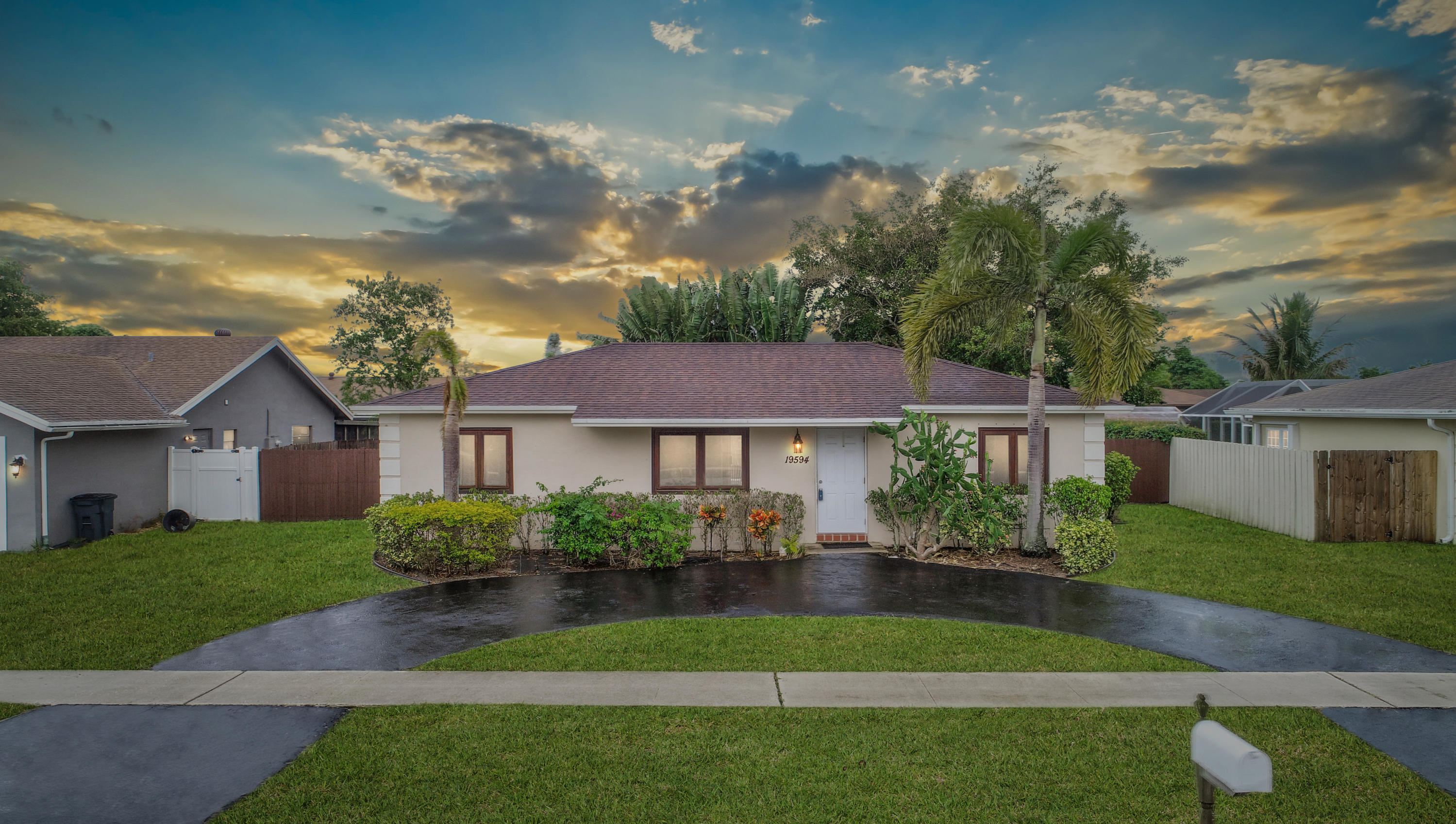 19594 Liberty Road Boca Raton, FL 33434 - Photo 53 of 53 a view of a house next to a yard with plants and large trees