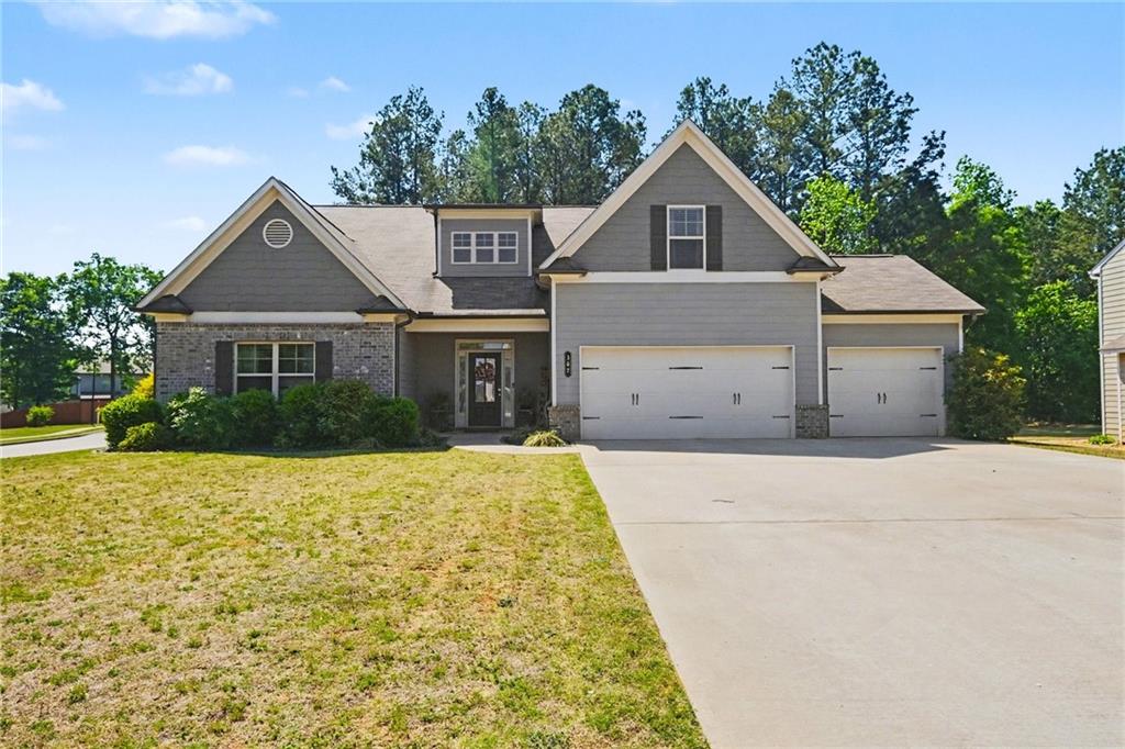 307 Fern Court Hoschton, GA 30548 - Photo 1 of 1 a front view of a house with a yard and garage