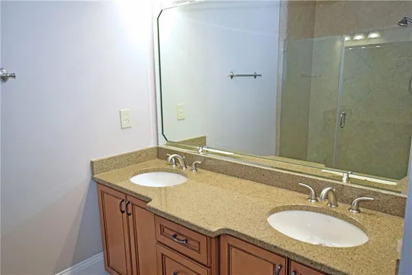 a bathroom with a granite countertop sink and a mirror