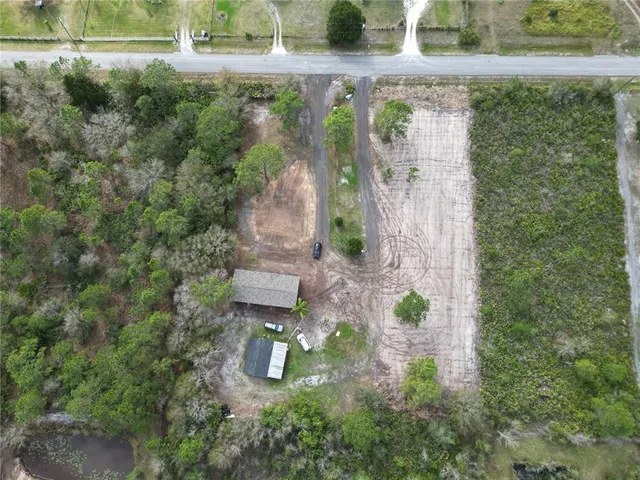 an aerial view of a house with a yard
