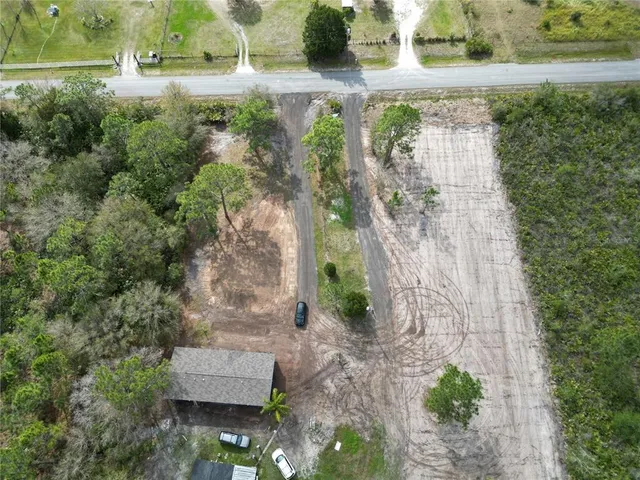 an aerial view of a house with outdoor space