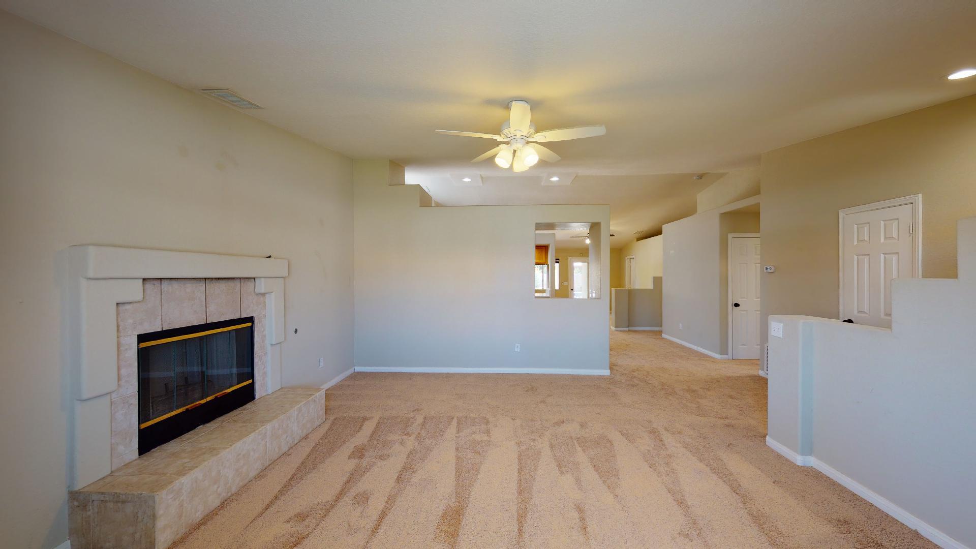 68373 Durango Road Cathedral City, CA 92234 - Photo 11 of 44 wooden floor fireplace and windows in an empty room