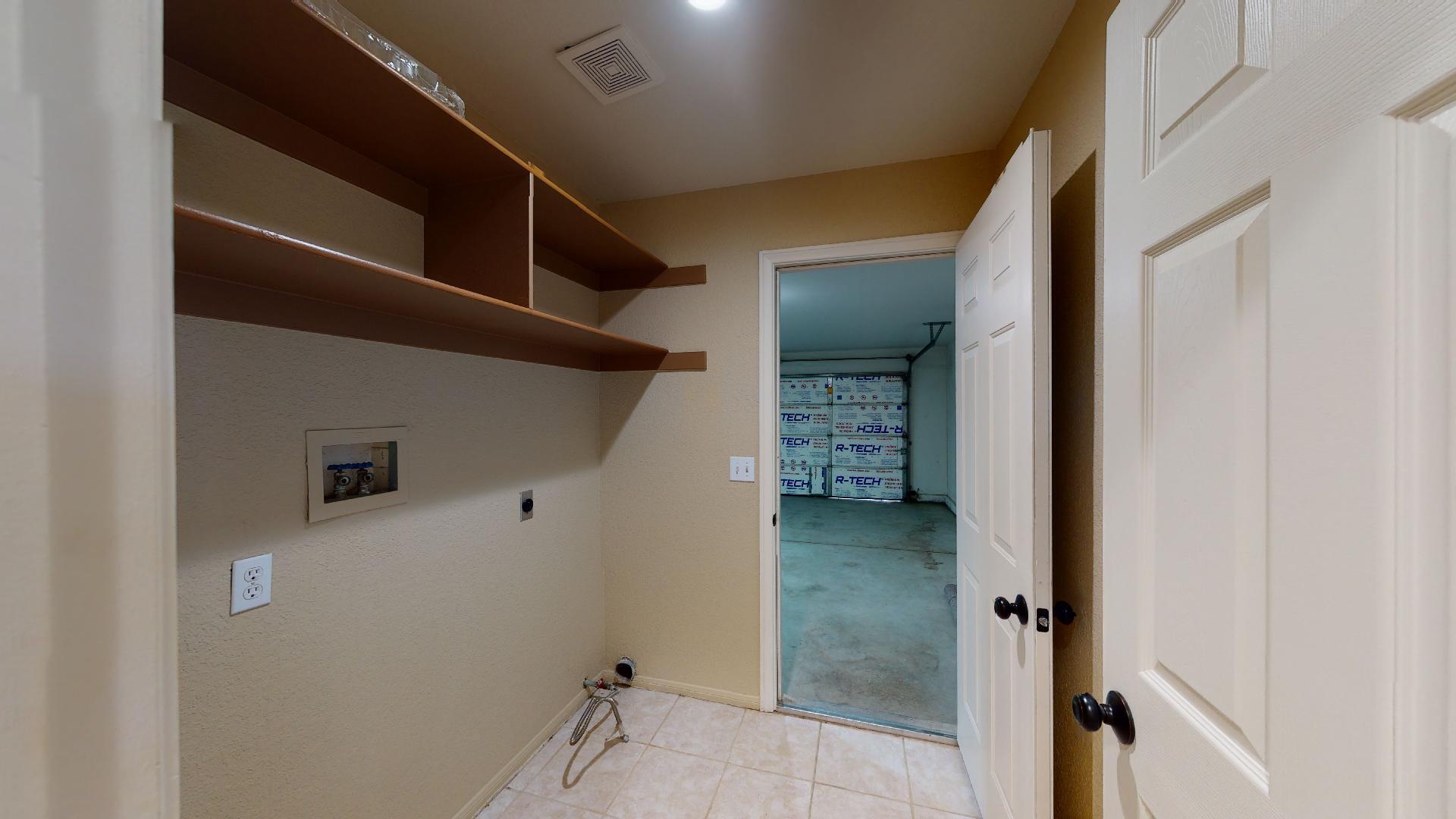 68373 Durango Road Cathedral City, CA 92234 - Photo 12 of 44 a view of a hallway with wooden shelves