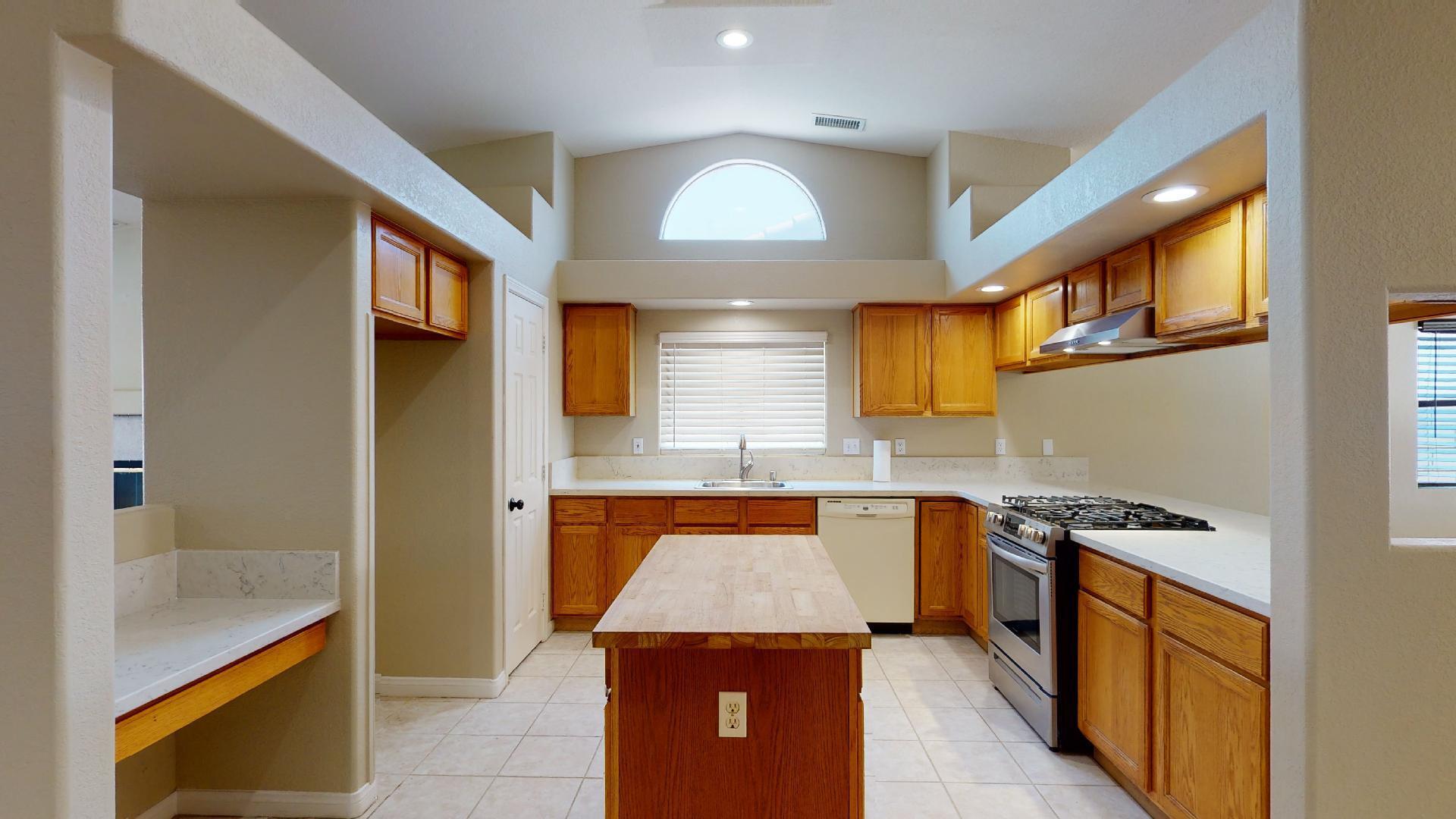 68373 Durango Road Cathedral City, CA 92234 - Photo 17 of 44 a kitchen with stainless steel appliances granite countertop a stove and a sink