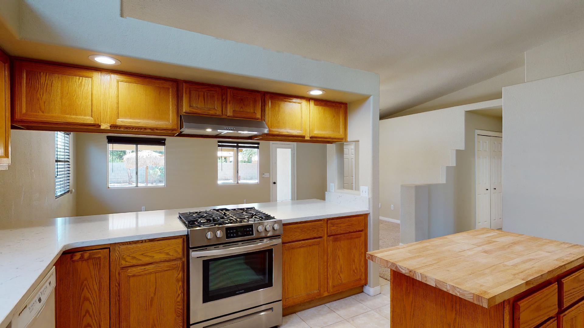 68373 Durango Road Cathedral City, CA 92234 - Photo 19 of 44 a kitchen with stainless steel appliances granite countertop a stove a sink and a refrigerator