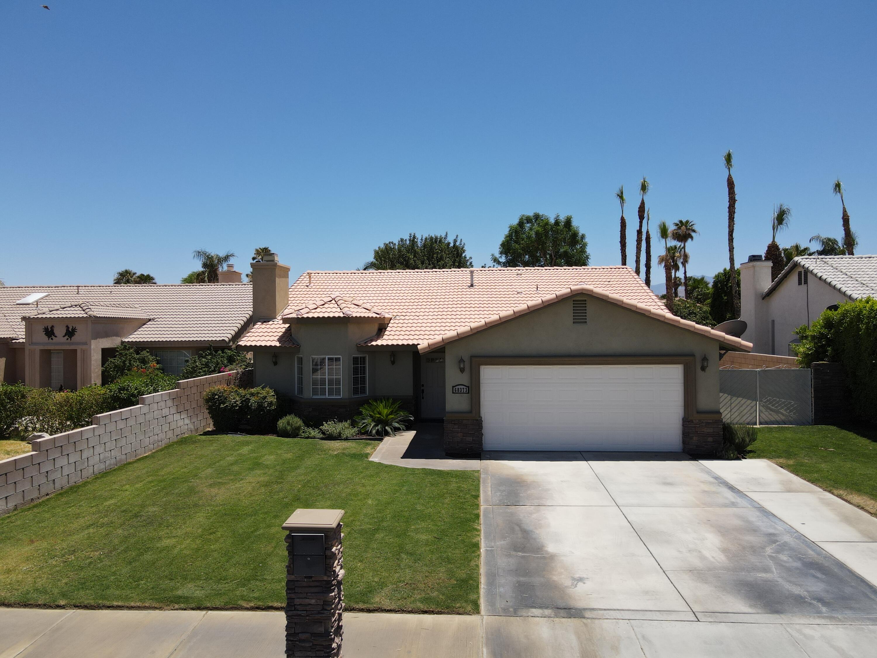 68373 Durango Road Cathedral City, CA 92234 - Photo 36 of 44 a front view of a house with a yard