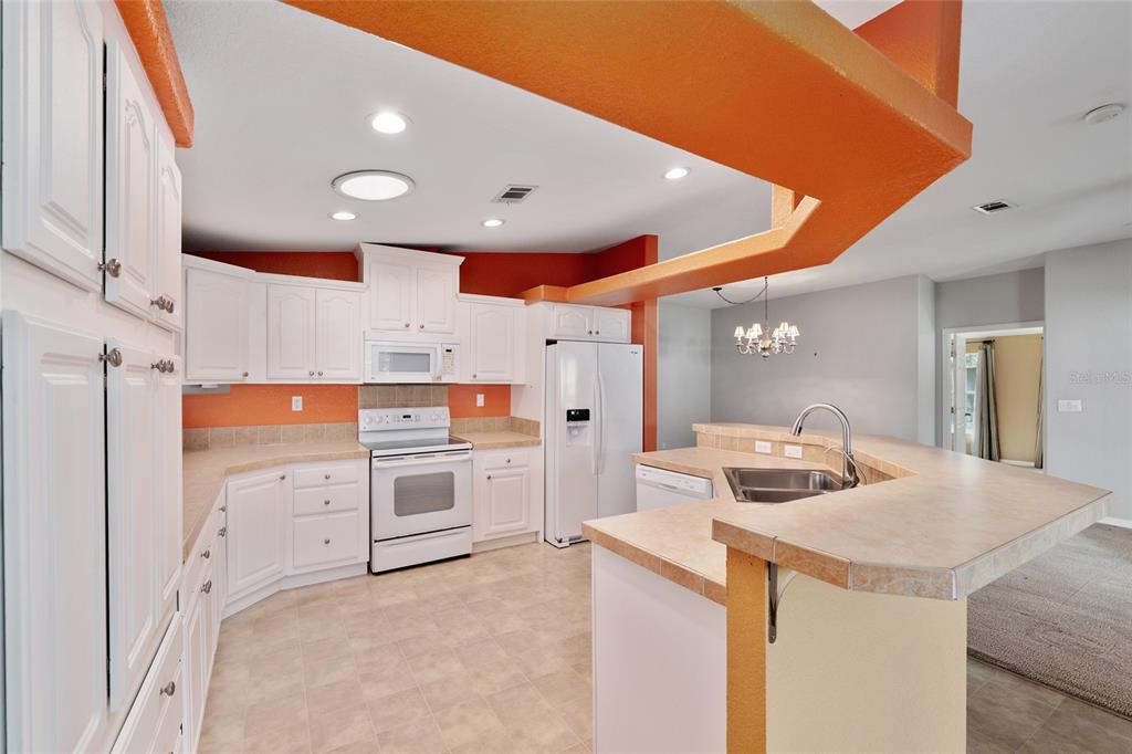 7863 Southwest 6th Place Ocala, FL 34474 - Photo 11 of 60 a kitchen with stainless steel appliances a stove a sink and a refrigerator