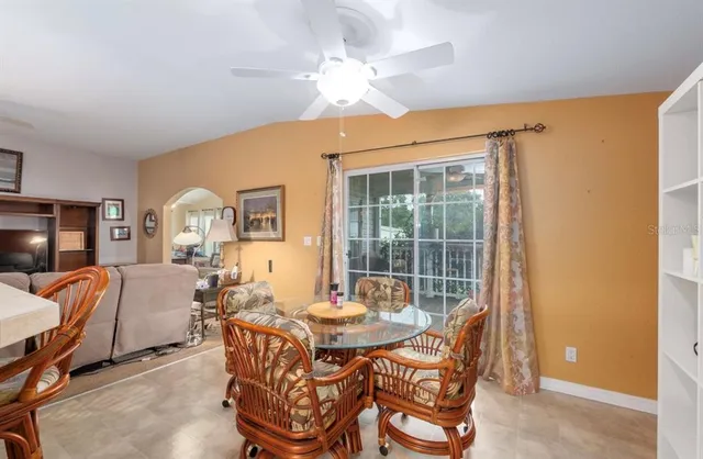 a dining room with furniture and a chandelier