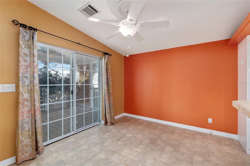 7863 Southwest 6th Place Ocala, FL 34474 - Photo 18 of 60 an empty room with a window and a ceiling fan