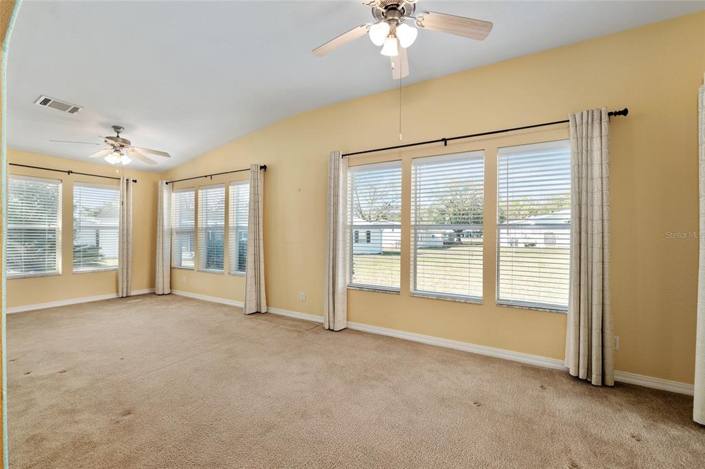7863 Southwest 6th Place Ocala, FL 34474 - Photo 28 of 60 a view of an empty room with chandelier fan and fire place