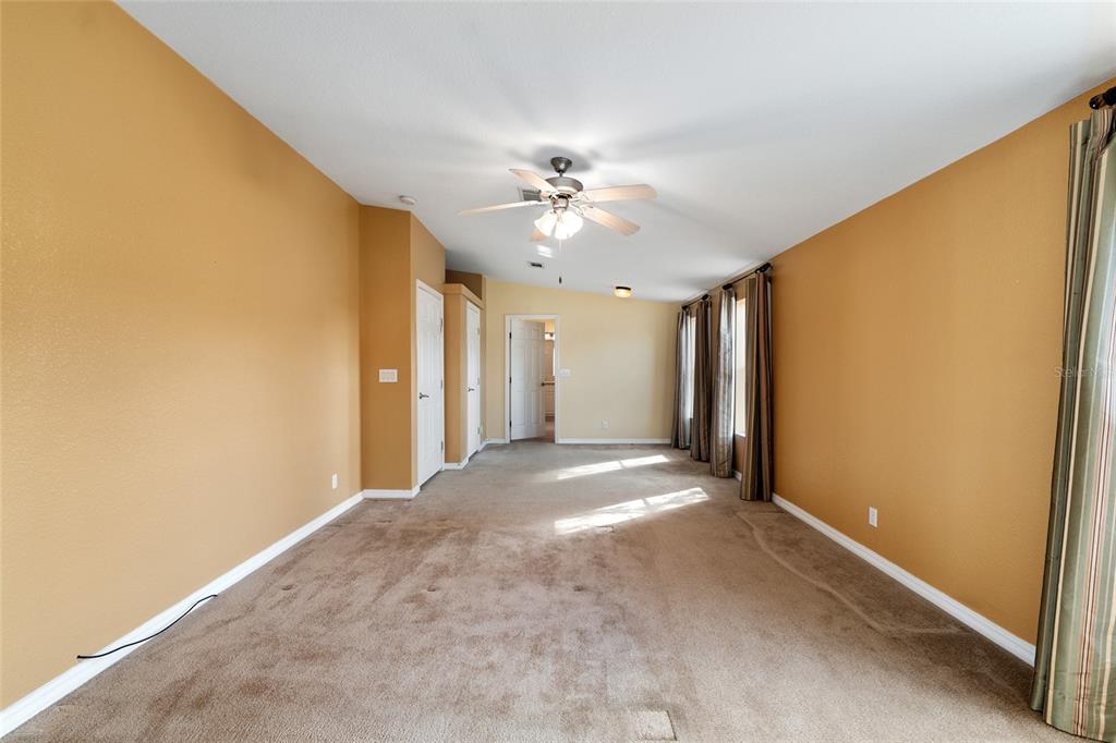 7863 Southwest 6th Place Ocala, FL 34474 - Photo 31 of 60 a view of a big room with chandelier fan and windows