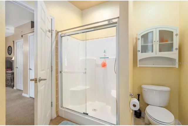 a living room with furniture a ceiling fan and a window