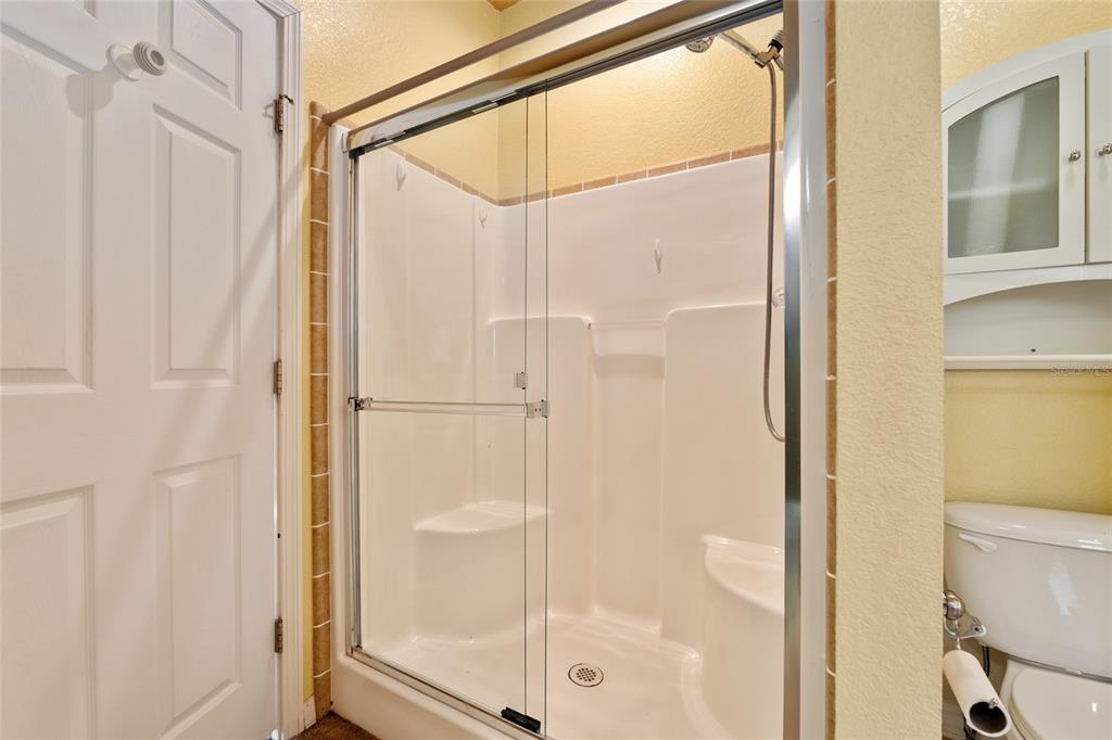 7863 Southwest 6th Place Ocala, FL 34474 - Photo 37 of 60 a bathroom with a glass shower door
