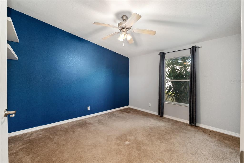 7863 Southwest 6th Place Ocala, FL 34474 - Photo 41 of 60 an empty room with fan and windows