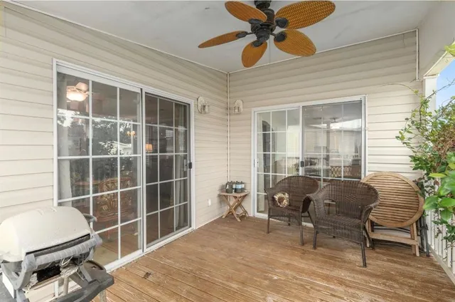 a view of a house with a yard and potted plants