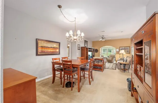 a view of a dining room with furniture and chandelier